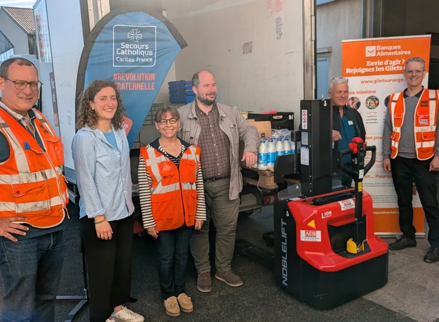Petite photo de famille avec le Secours catholique du Loiret, la Banque alimentaire du Loiret et un transpalette ergonomique. Photo Alban Gourgousse.